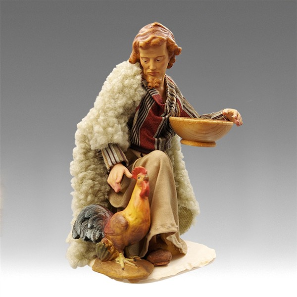 Hirt kniend mit Hahn Hirt kniend mit Hahn
