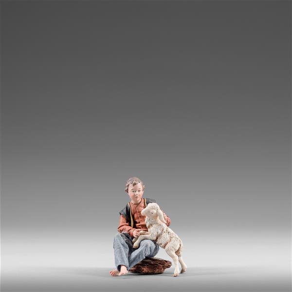 Kind sitzend mit Lamm Kind sitzend mit Lamm